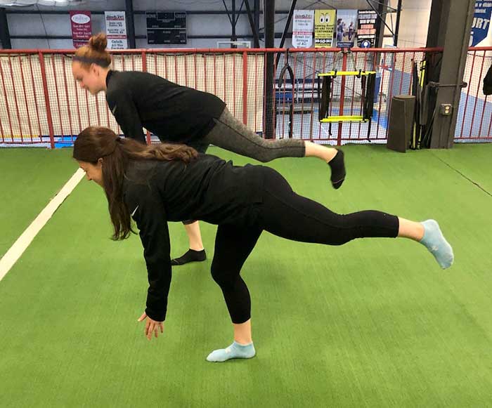 2 girls doing Inverted Hamstring Stretch