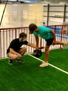 A trainer training a student in COVID-19 Pandemic.