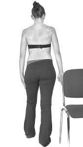 Woman pressing forearm into stable surface behind her